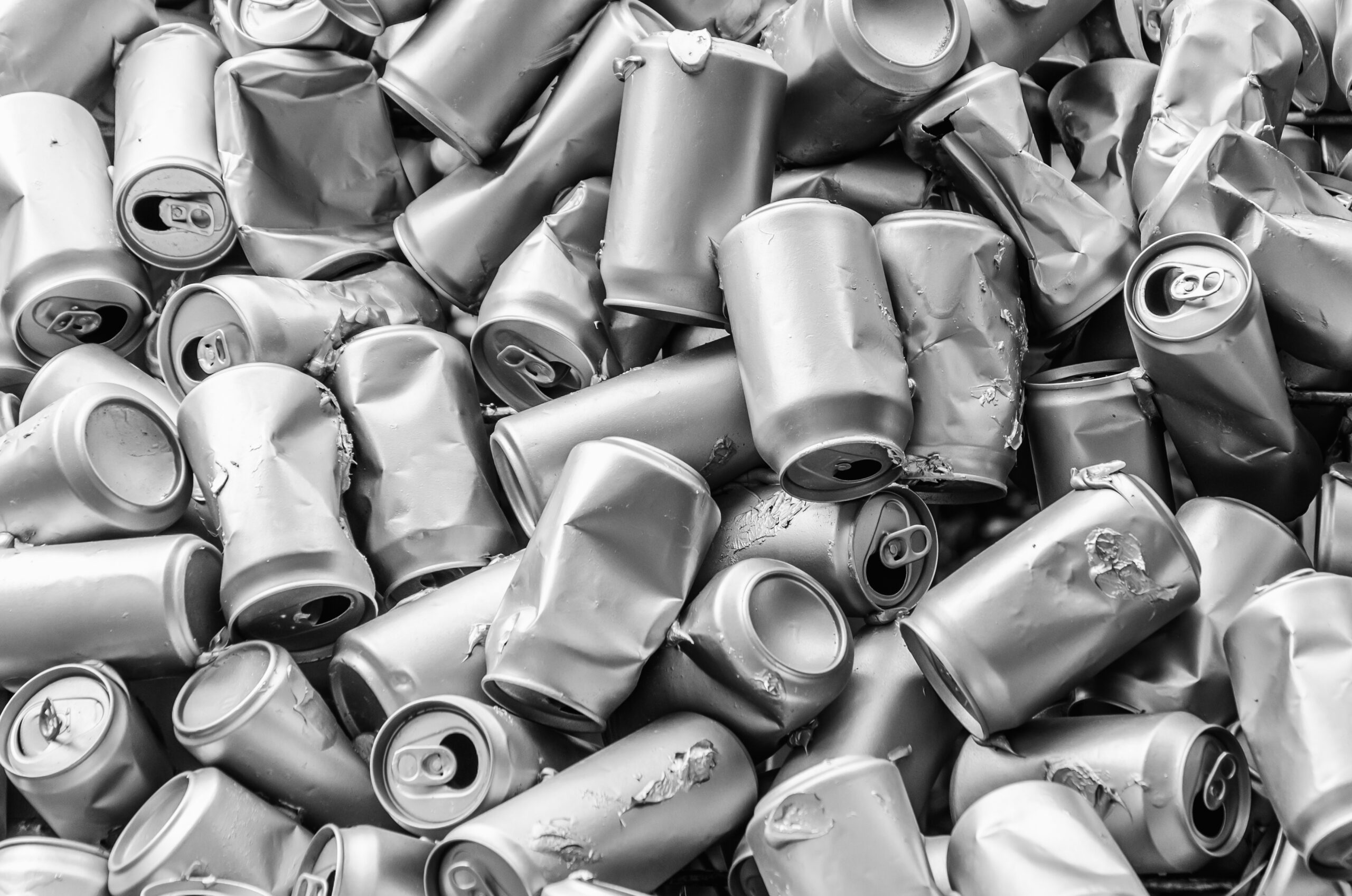 bunch of crumpled empty aluminum cans. The concept of processed waste. Background, texture of piles of crushed aluminum cans